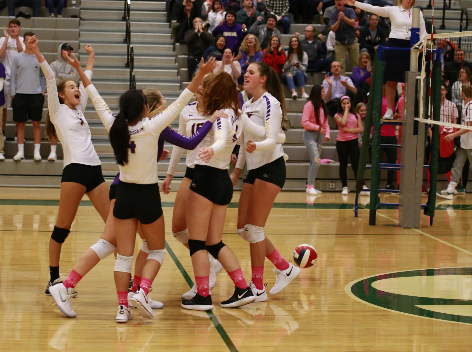CLEAN SWEEP: The team celebrates together with cheers after scoring a point. The Issaquah Girls' Varsity Volleyball Team beat rival Skyline Wednesday night in just three matches.