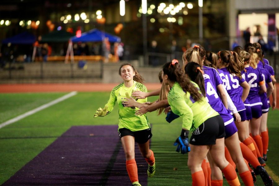 KICKING+MS%3A+Senior+goalkeeper+Chloe+Lang+and+orchestrator+of+the+MS+fundraiser+leads+the+way+for+the+introductions+for+the+Issaquah+Varsity+team%2C+emotions+in+full+swing