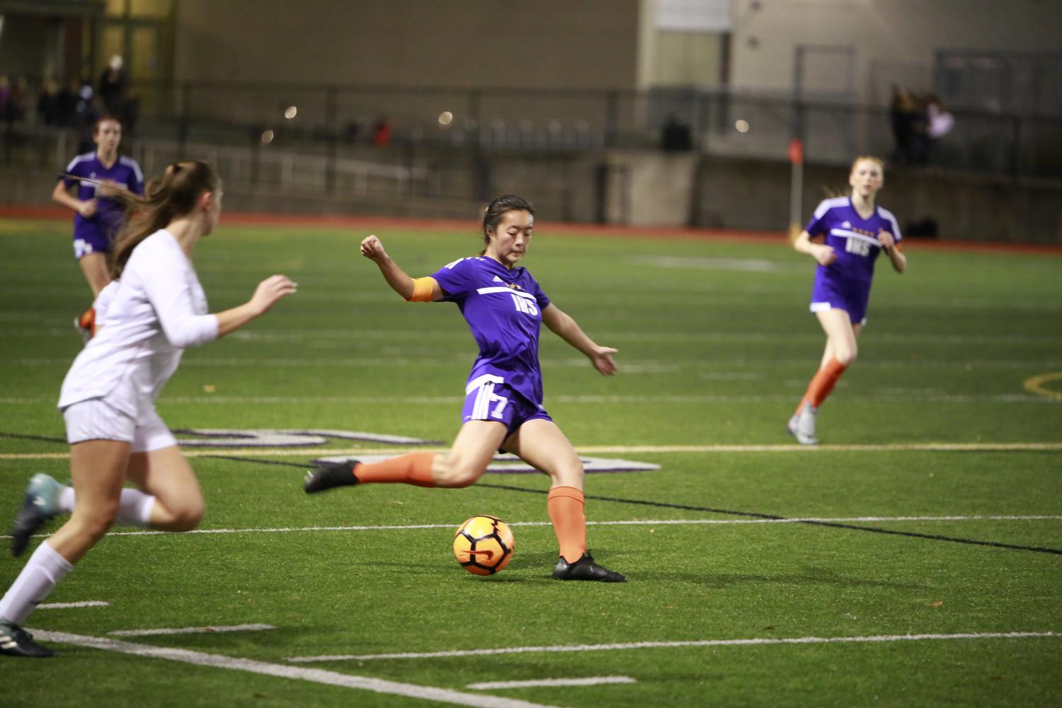 SKILLFUL PLAY: Senior Sarah Kim attacks the ball. The Issaquah Girls' Varsity Soccer Team keeps the ball close to the ground, plays aggressively, and works well as a unit.