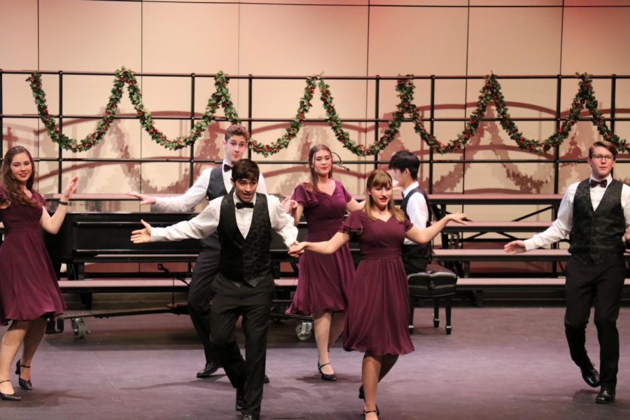 HOLIDAY CHEER: Seniors Chris Benis and Mia Foster perform with Mix It Up in Swing into Christmas Medley. The creative choreography really added to the groups lively performance.