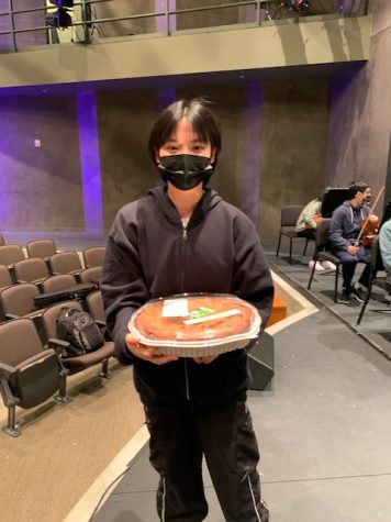 Freshman Justine Wang stands with an apple pie that she won from the Pi Day Contest.
